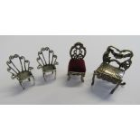 A silver Dutch miniature dolls house dining chair in repousse style with semi open back and embossed