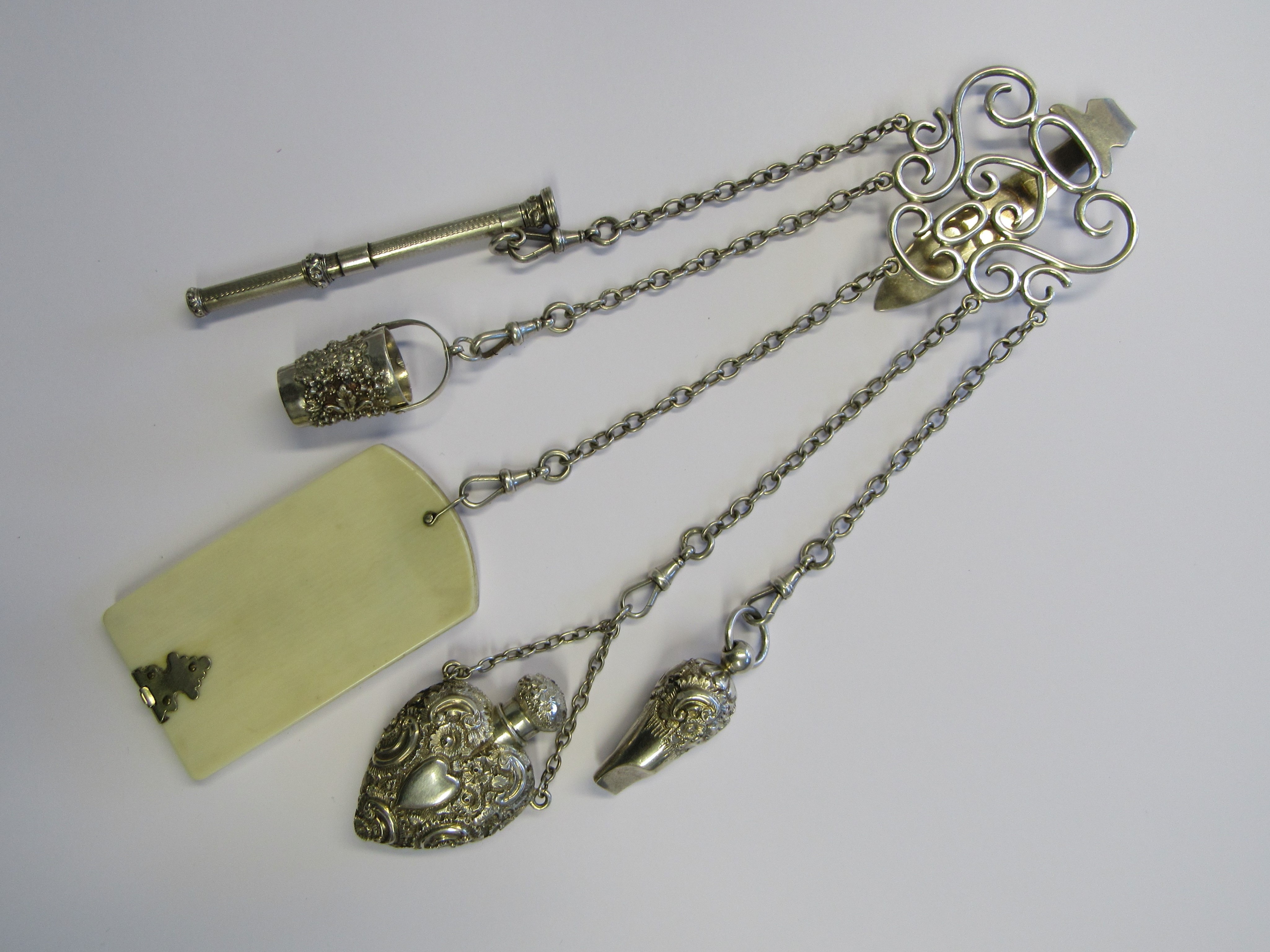 An Edwardian large silver Chatelaine with five suspended attachments. The clip hallmarked for