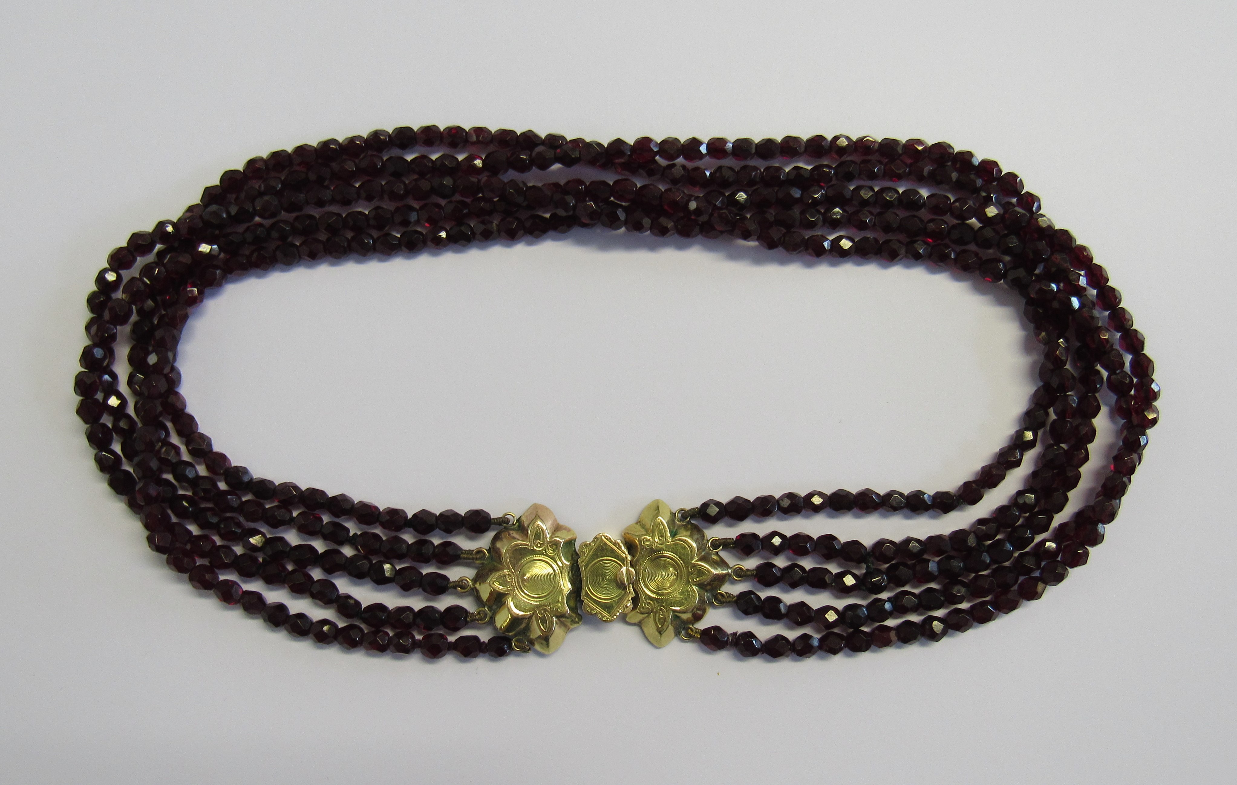 A Victorian Raj garnet choker necklace fitted with a marked 585 bi-coloured gold lotus shaped clasp.