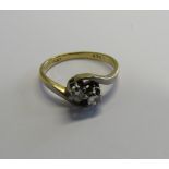 An 18ct gold, platinum and diamond two stone dress ring. The two small diamonds in tension style