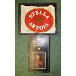 A cast Stella Artois advertising plaque in mint condition together with a Shell Great Britons