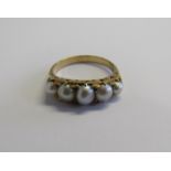 An early 20th century 18ct gold graduated five pearl (untested) dress ring with the largest pearl