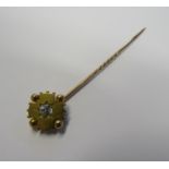 A 15ct gold star set old European cut diamond stick pin with the diamond diameter measuring