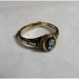 A Victorian unmarked gold (tested) mourning ring with a small black lacquered signet panel with