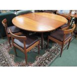 A Teak Dining Table with centre folding drop leaf together with matching six dark brown PVC