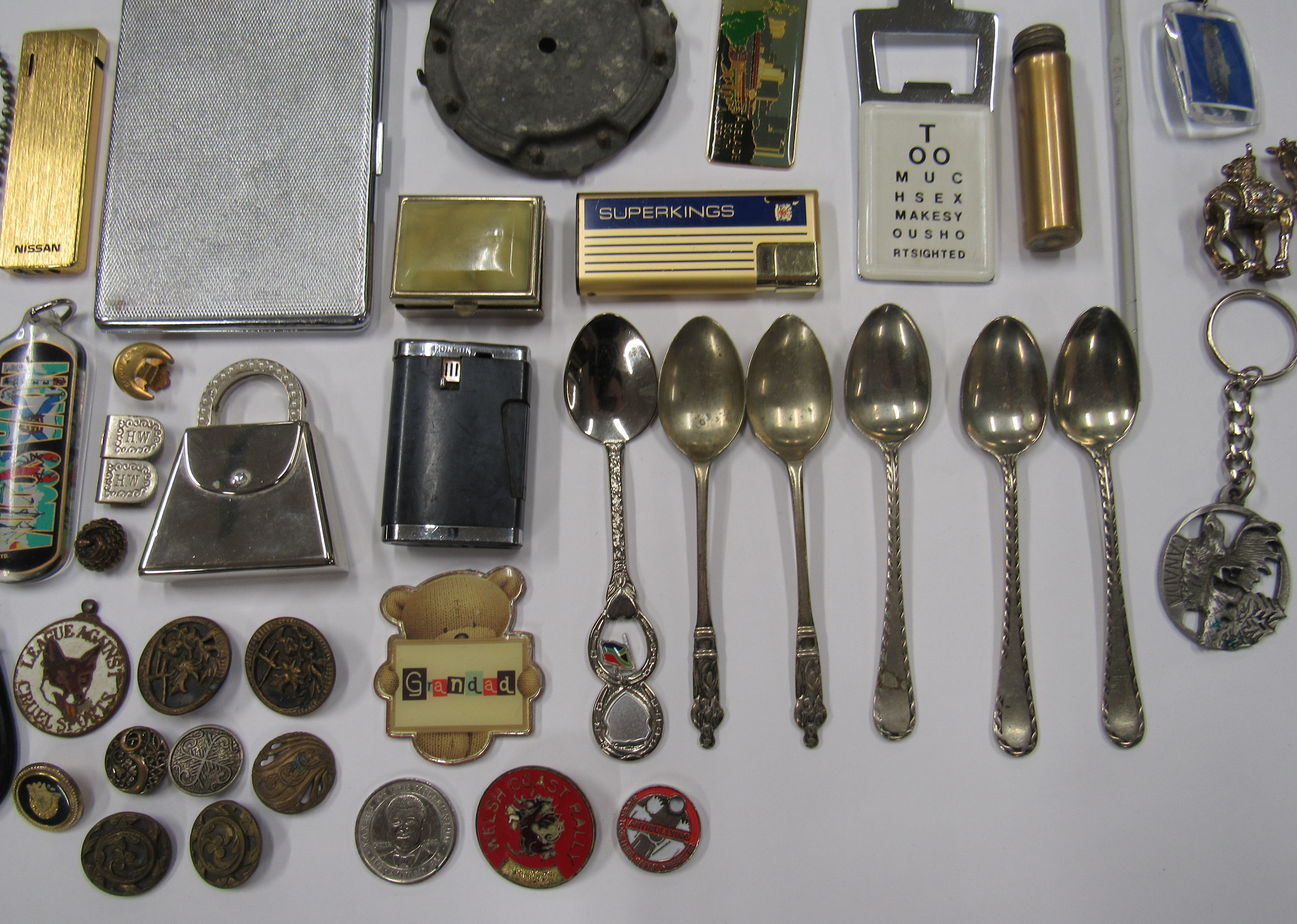 A miscellaneous collection of items to include a cigarette case, lighter key rings and buttons. - Image 2 of 3