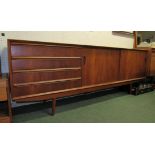 A Teak sideboard with two sliding doors and four drawers 220cm x 45cm x 79cm approx.