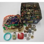A collection of costume jewellery, loose beads, buttons, etc. contained in a vintage TEA TIME