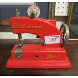 A children's tinplate Vulcan red sewing machine