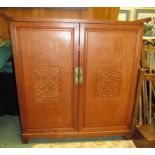 An Oriental style decorative drinks cupboard with opening lid to reveal matching front panel design.