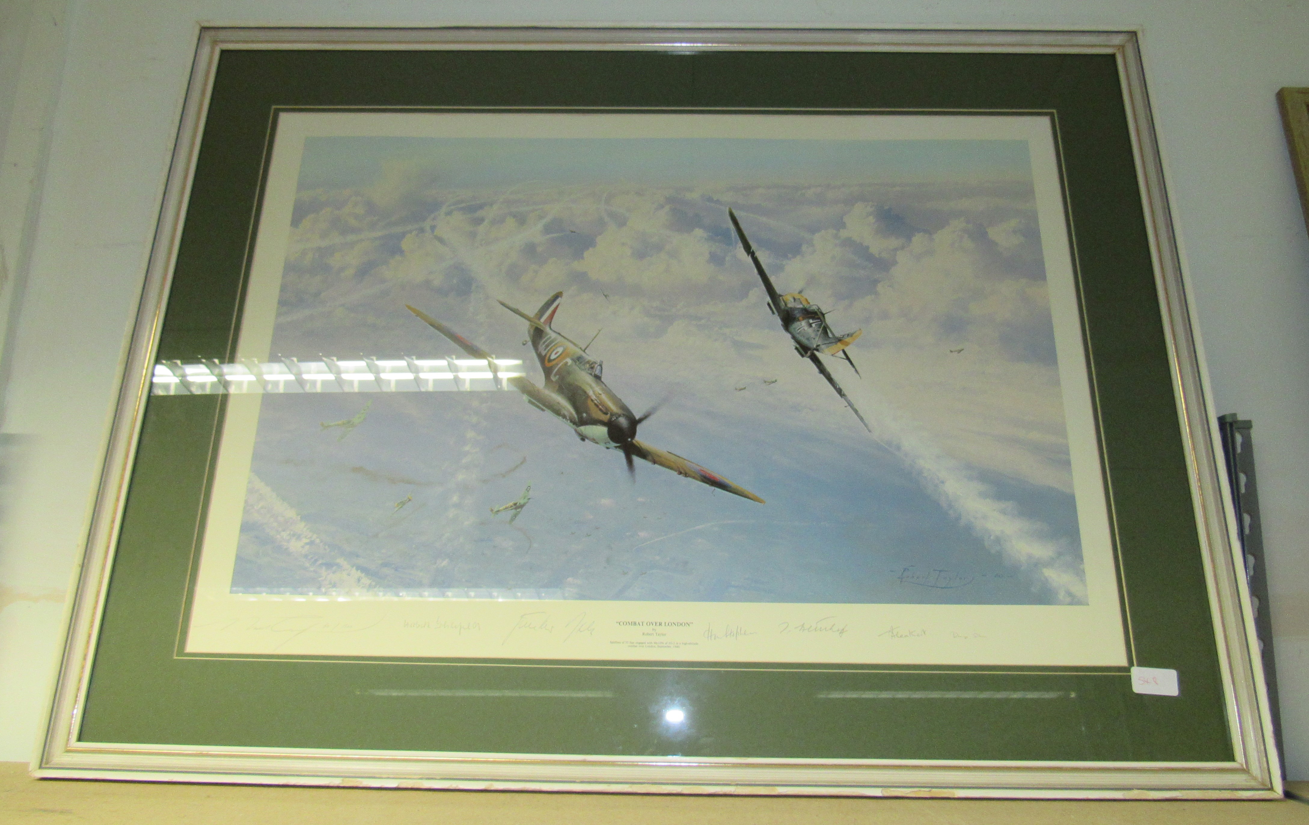 A framed glazed signed print by Robert Taylor 'Combat Over London'. Size - 100x77cm approx.