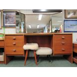 A Stag teak dressing table with bi-fold mirror and three drawers to either side of a kneehole