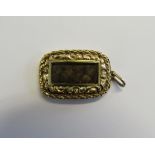 Memorial - A Victorian unmarked gold (tested) pendant piece of oblong form set with a glass