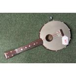 A Selcol wind-up musical banjo that plays 'Oh Susanna'