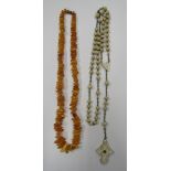 An amber chip graduated 'dog tooth' necklace measuring 48cm together with a cream bead Rosary