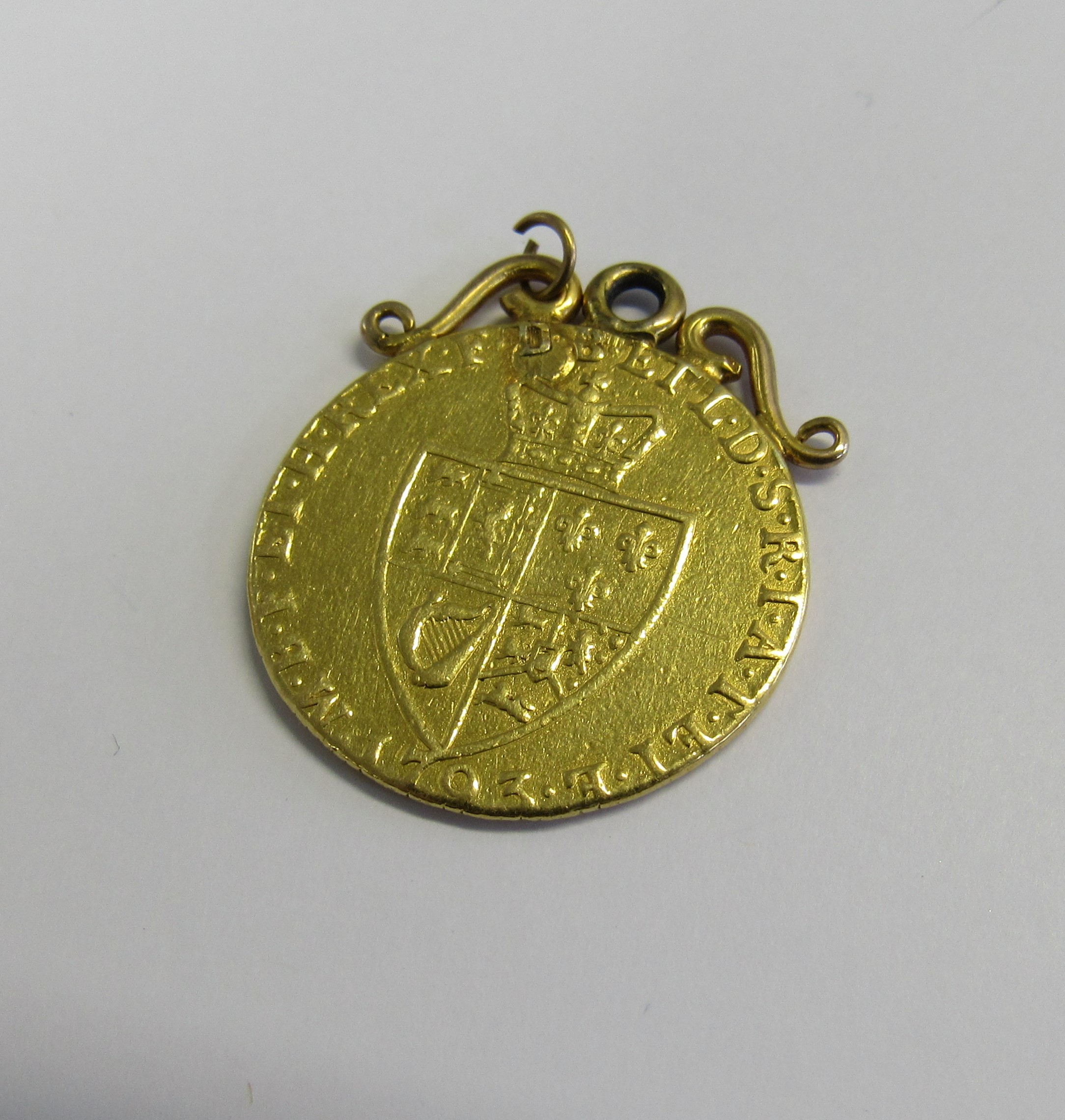 A George III 1793 gold spade Guinea, adapted for pendant/fob with an unmarked scroll top. Total