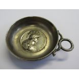 A white metal coin dish with a French medallion inset to the base and a coiled snake handle.