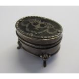 An Edwardian silver oval trinket box on four splayed feet with a faux tortoiseshell lid with