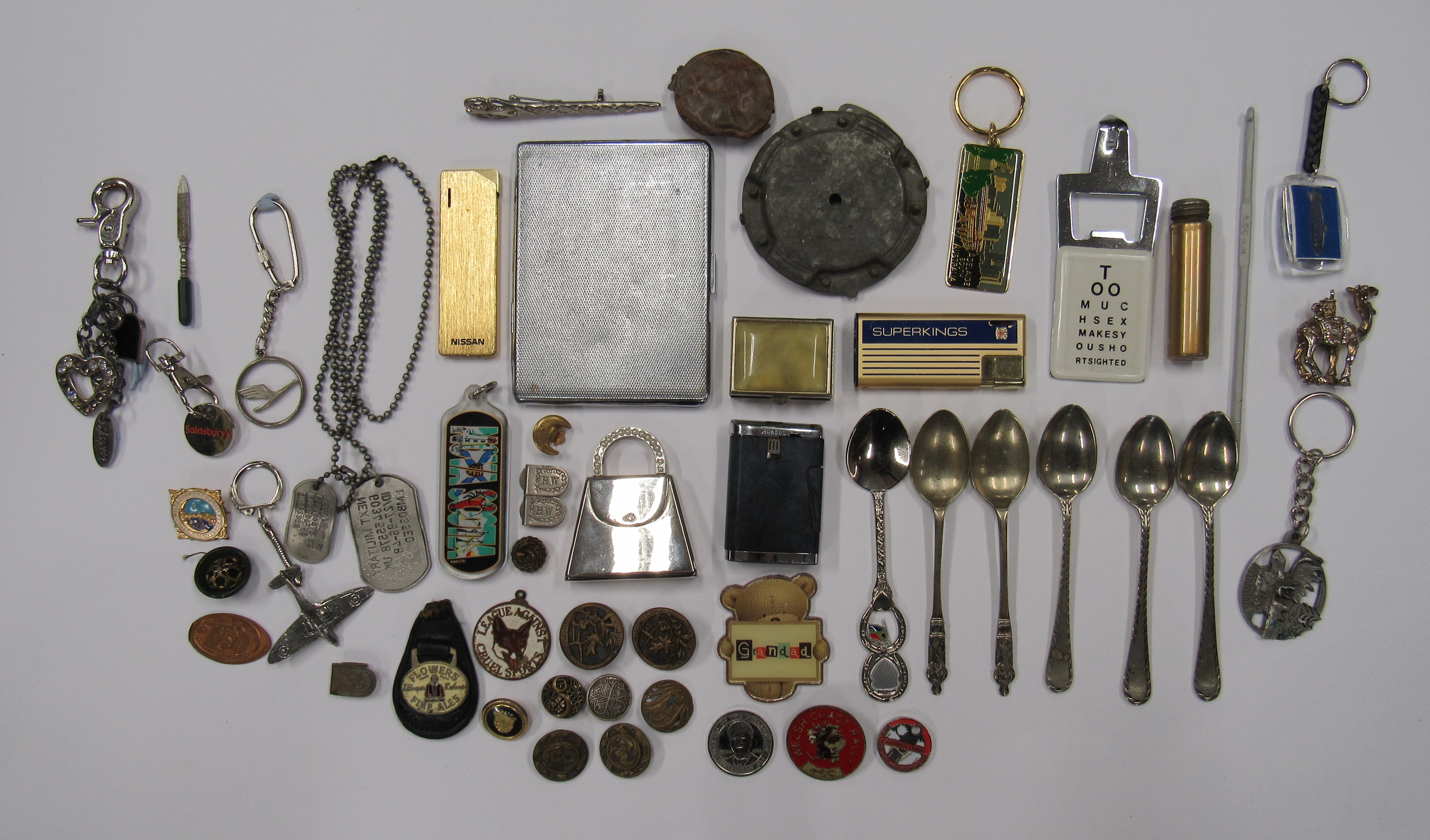 A miscellaneous collection of items to include a cigarette case, lighter key rings and buttons.