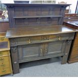 OAK SIDEBOARD IN THE ARTS AND CRAFTS STYLE WITH GALLERY BACK OVER LONG DRAWER WITH PANEL DOORS