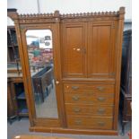 LATE 19TH CENTURY OAK WARDROBE WITH CENTRALLY SET DRAWERS WITH PANEL DOORS ABOVE FLANKED PANEL DOOR