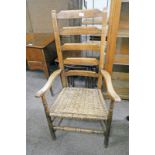 LATE 19TH OR EARLY 20TH CENTURY ELM ARMCHAIR WITH BASKET WORK SEAT