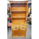 PINE DRESSER WITH PLATE RACK BACK OVER 2 DRAWERS WITH 2 PANEL DOORS BELOW.