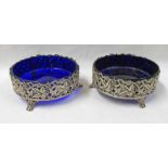 PAIR OF CIRCULAR SILVER DISHES WITH PIERCED LEAF WORK, DECORATION & BLUE GLASS LINERS,