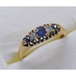 SAPPHIRE & DIAMOND 5 STONE DIAMOND RING IN YELLOW METAL SCROLL SETTING MARKED 18