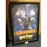 FRAMED HARRY POTTER POSTER WITH CAST SIGNATURES INCLUDING WARWICK DAVIS AND OTHERS.