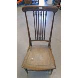 EARLY 20TH CENTURY OAK SPAR BACK NURSING CHAIR ON TURNED SUPPORTS