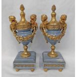 PAIR OF EARLY 20TH CENTURY FRENCH URNS WITH GILT METAL MOUNTS AND LIDS ON A GREY MARBLE BODY,