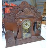 19TH CENTURY CLOCK WITH GILT PAINTED GLASS PANEL MOUNTED ON A CARVED MAHOGANY STAND WITH SERVANTS