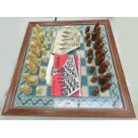 HEBRIDEAN "LEWIS" CHESS PIECES ON A SEWN WORK CHESS BOARD WITH WOODEN FRAME AND GLASS TOP