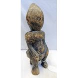 CARVED WOOD TRIBAL AFRICAN FIGURE OF A FIGURE SITTING ON A STOOL,