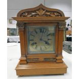 EARLY 20TH CENTURY WALNUT MANTLE CLOCK WITH CARVED DECORATION WITH SILVERED DIAL 39CM TALL