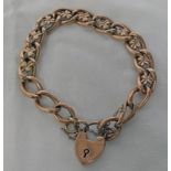 CURB LINK BRACELET MARKED 9CT ON LINK WITH 9CT GOLD PADLOCK,