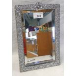 SILVER FRAMED MIRROR WITH EMBOSSED FLORAL DECORATION,