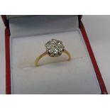DIAMOND SET CLUSTER RING WITH 7 CIRCULAR CUT DIAMONDS Condition Report: Ring size: L