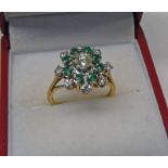 EMERALD AND DIAMOND SET CLUSTER RING MARKED 18CT THE CENTRALLY SET DIAMOND OF APPROX. 0.