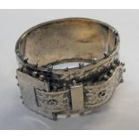 SILVER BUCKLE DECORATED BANGLE WITH FOLIATE ENGRAVED DECORATION Condition Report: