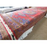 RED GROUND MIDDLE EASTERN CARPET - 307 X 210CM Condition Report: Very slight fading
