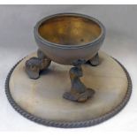 CIRCULAR LATE 19TH OR EARLY 20TH CENTURY BRASS BOWL ON FISH SUPPORTS ON HARDSTONE BASE,