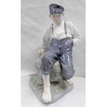 ROYAL COPENHAGEN FIGURE OF A YOUNG BOY SET ON A ROCK - 31 CM TALL