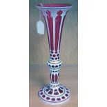 LATE 19TH CENTURY RED GLASS VASE WITH WHITE ENAMEL & GILT DECORATION WITH FLUTED TOP - 33 CM TALL