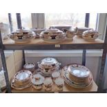 SELECTION OF PORCELAIN DINNERWARE WITH GILT DECORATION OVER TWO SHELVES