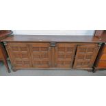 OAK SIDEBOARD WITH 4 PANEL DOORS ON BRACKET SUPPORTS, THE INTERIOR WITH 2 DRAWERS TO EITHER SIDE .