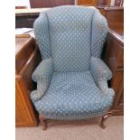 WING ARMCHAIR WITH GREEN COVERING & SHAPED SUPPORTS