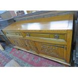 EARLY 20TH CENTURY ARTS & CRAFTS OAK SIDEBOARD WITH 2 DRAWERS OVER 3 CARVED FLORAL PANEL DOORS