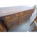 EARLY 20TH CENTURY ARTS & CRAFTS SIDEBOARD WITH 3 DRAWERS & 3 CARVED PANEL DOORS ON BRACKET